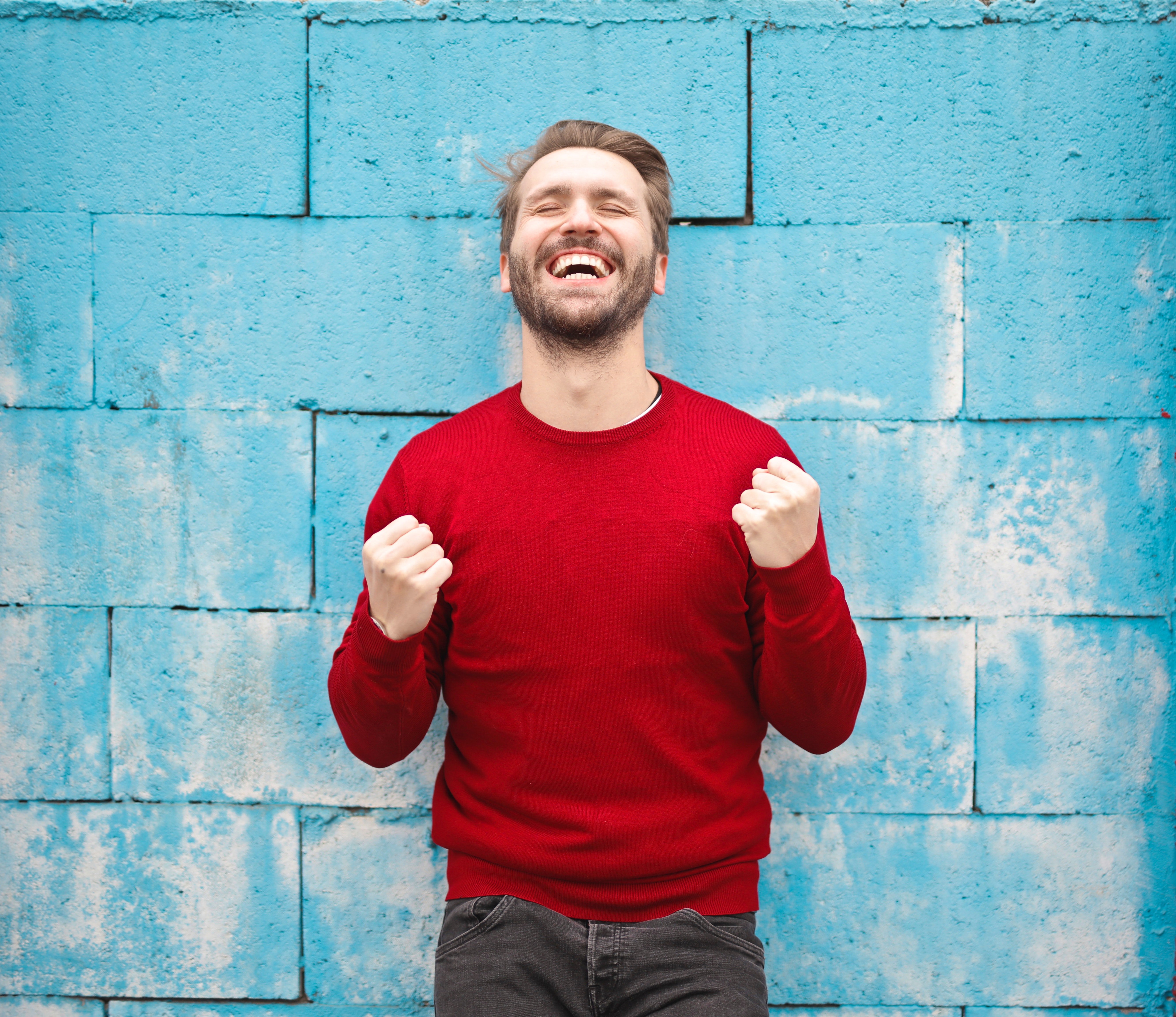 Happy Man Blue Wall Red Sweater